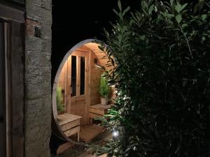 a circular mirror in a garden at night at Boutique Cottage - Sauna and Jacuzzi - El Clandestino in Érezée