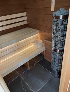 a wooden bench sitting in a sauna at 4 DOMY in Dolní Morava