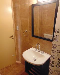a bathroom with a sink and a mirror at Hermoso departamento en San Telmo in Buenos Aires