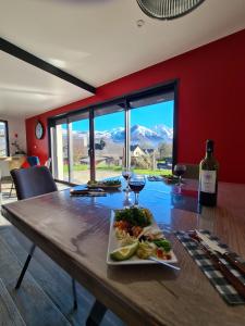 a table with a plate of food and a glass of wine at Maison le Pré de Paul in Saint-Savin