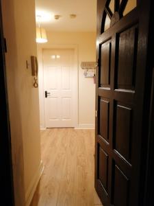 an empty hallway with a door and a hallwayngth at Barrow mews views in Carlow