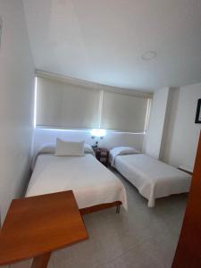 Hotel Manhattan Barbosa客房内的一张或多张床位