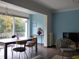 a dining room with blue walls and a table and chairs at MAISON APPARTEMENT LA BAULE LES PINS in La Baule