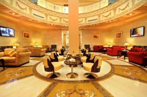 a lobby with chairs and tables in a building at Dar Al Naem Hotel in Medina