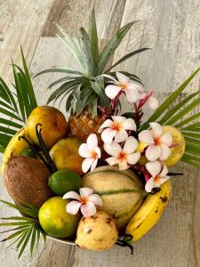 a pile of tropical fruits and flowers on a table at Couleur Caraïbes in Saint-François