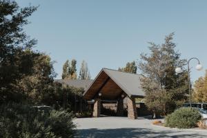 a wooden building with a gambrel roof at Edgewater Hotel in Wanaka