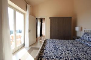 a bedroom with a bed and a large window at Villa Stauder in Genzano di Roma +11 photos