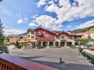 a large apartment building with a parking lot at Beautiful true ski-in/out condo for family trip! in Sun Peaks