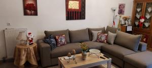 a living room with a couch and a table at Barbie-House in Kalabaka