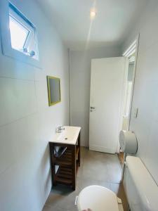 a bathroom with a sink and a toilet and a tub at Hostel Playa Grande Austral in Mar del Plata