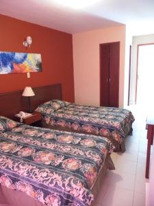 Ένα ή περισσότερα κρεβάτια σε δωμάτιο στο Hotel Betoma
