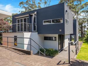 a house with a black and white facade at Rigel by Experience Jervis Bay in Vincentia