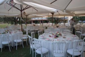 a group of tables and chairs with white table cloths at Borgo S.Maria Di Vulci in Montalto di Castro