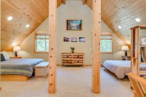 a bedroom with two beds and a wooden ceiling at Hot Tub Cool Views: Roaring Creek Cabin in Leavenworth