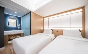a bedroom with two beds and a sink in it at HOTEL701 Masan in Changwon +50 photos