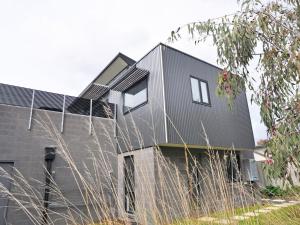 a house with a black roof at Luxe Townhouse 2 Inlet Side Wifi in Inverloch