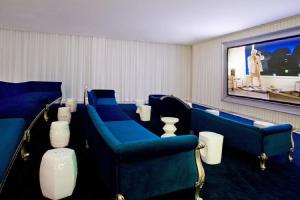 a waiting room with blue chairs and a flat screen tv at Splendid Unit outstanding View-W Hotel Brickell in Miami