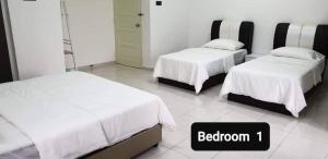 two beds in a room with a sign that reads bedroom at Sunrise Homestay in Alor Setar