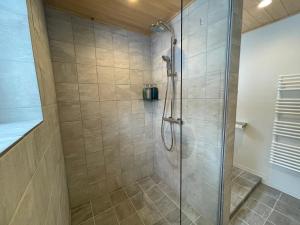 a bathroom with a shower with a glass door at The Bunker at Yunosato in Rankoshi +12 photos