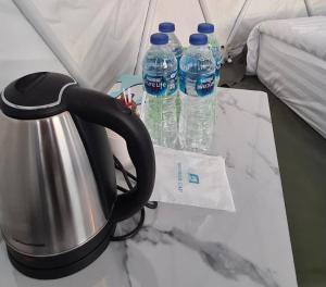 two bottles of water sitting on top of a counter at ข้างเขาแคมป์ Khangkhao Camp in Ban Yang Khun Wang
