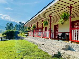 un edificio con un camino de piedra junto a un campo verde en Hotel Rural SAN REMO, en Santa Rosa de Cabal