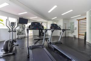 een fitnessruimte met loopbanden en crosstrainers in een kamer bij Oscar Freire Apart in Sao Paulo