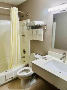 a bathroom with a white toilet and a sink at Super 8 by Wyndham Benton Harbor St Joseph in Benton Harbor