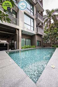 a swimming pool in front of a building at Like Sukhumvit 22 in Bangkok