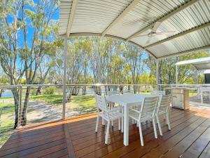 a white table and chairs on a deck at BIG4 Deniliquin Holiday Park in Deniliquin