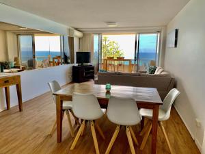 a living room with a wooden table and chairs at Park Towers Holiday Units in Gold Coast