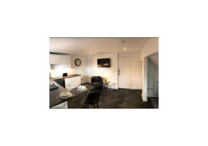 a view of a kitchen and a living room at Grey Apartment in Inverness