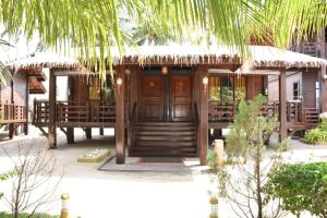 a resort with a wooden door and some chairs at Nilaveli Beach Resort - Level 1 Certified in Nilaveli