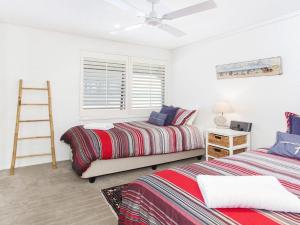 a bedroom with two beds and a ladder in it at Aroona at Minnamurra in Minnamurra