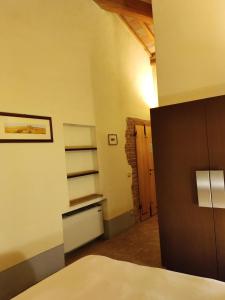 a room with a bed and a book shelf at La Locanda del Vino Nobile in Sant'Albino