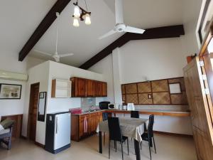 a kitchen with a table and chairs and a refrigerator at Nickles Park Resort in Panglao