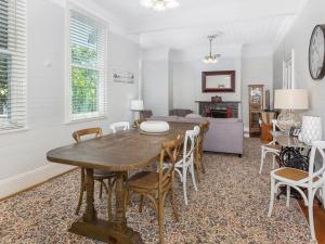 a dining room with a wooden table and chairs at Blake House - SPECIAL OFFER STAY 3 PAY for 2 OR 25PERCENT OFF MIDWEEK in Kiama