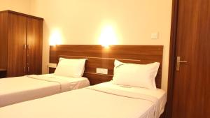 Postel nebo postele na pokoji v ubytování Hotel Rhythm Grand Suite