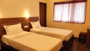 Postel nebo postele na pokoji v ubytování Hotel Rhythm Grand Suite