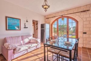 a living room with a couch and a table at Es turo de Mallorca in Ses Salines