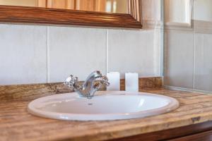 a bathroom sink with a faucet on a counter at Es turo de Mallorca in Ses Salines +13 photos