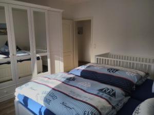 Katil atau katil-katil dalam bilik di Ferienwohnung Heimathafen