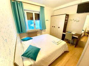Rúm í herbergi á Hotel B&B Lorenzini Ski