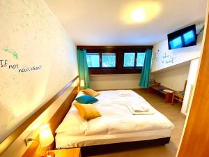 Rúm í herbergi á Hotel B&B Lorenzini Ski