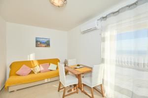 a living room with a table and a couch at Apartments BARO in Maranovići +17 photos