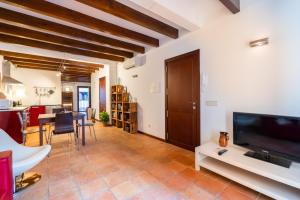 a living room with a large flat screen tv and a table at POC A POC SUITES in Palma de Mallorca