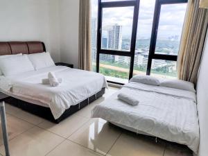 a bedroom with two beds and a large window at Centrus Soho Cyberjaya by IdealHub in Cyberjaya +139 photos