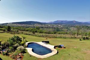 an overhead view of a swimming pool in a field at Waterval Self-Catering Holiday Home in Sabie