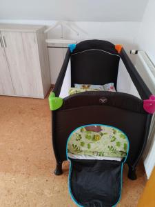 Una silla negra para niños con una almohada. en Haus an der Radau, en Bad Harzburg