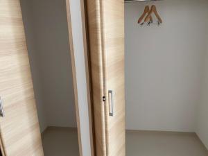 a door in a room with a closet at PLEASANT STAY Sunayama in Miyako-jima