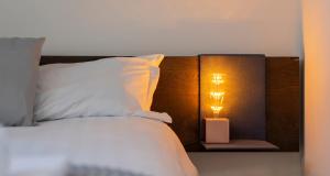Posteľ alebo postele v izbe v ubytovaní JOIVY Cosy Apt in Como Centre